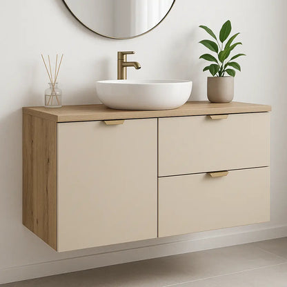 Waschtischunterschrank Orio 100 cm mit Kaschmir-Fronten und Eiche Artisan Korpus, integriertem Wäschekorb und schwarzen Griffen im modernen Badezimmer.